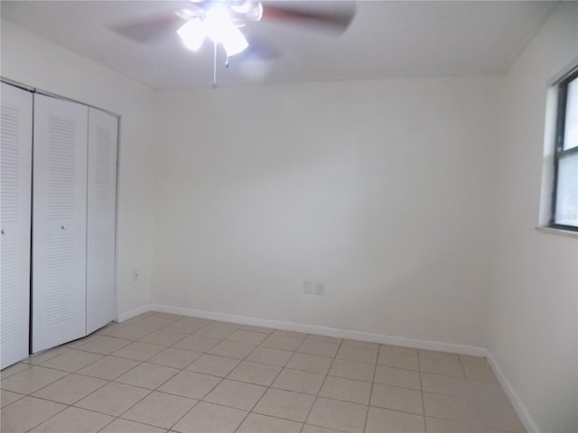 2811 SW Archer Rd Unit W 191, Gainesville, FL 32608 - unfurnished bedroom with a closet, a ceiling fan, baseboards, and light tile patterned flooring