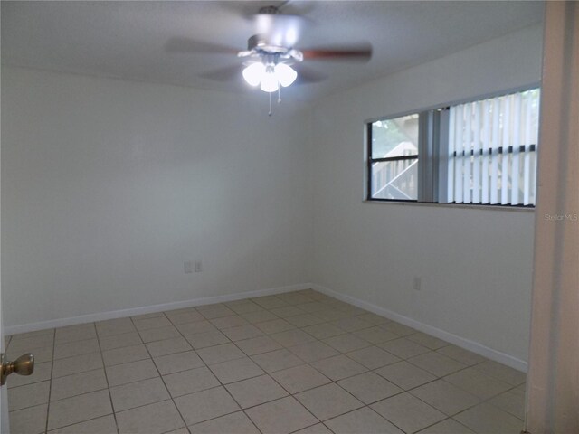 2811 SW Archer Rd Unit W 191, Gainesville, FL 32608 - empty room with ceiling fan, light tile patterned floors, and baseboards