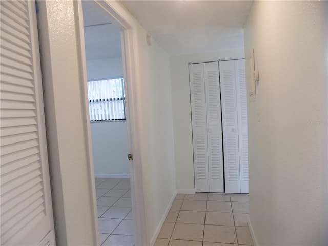 2811 SW Archer Rd Unit W 191, Gainesville, FL 32608 - hallway with light tile patterned flooring and baseboards
