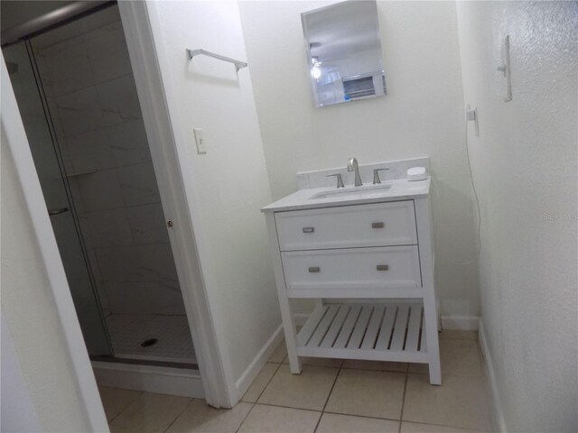 2811 SW Archer Rd Unit W 191, Gainesville, FL 32608 - bathroom with a shower stall, tile patterned flooring, vanity, and baseboards