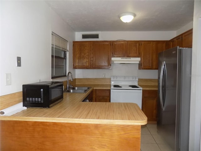 2811 SW Archer Rd Unit W 191, Gainesville, FL 32608 - kitchen featuring stainless steel refrigerator with ice dispenser, white range with electric cooktop, a sink, under cabinet range hood, and black microwave