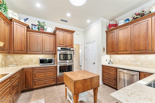 19138 NW 76th Ave, Alachua, FL 32615 - kitchen with ornamental molding, visible vents, decorative backsplash, light stone countertops, and appliances with stainless steel finishes
