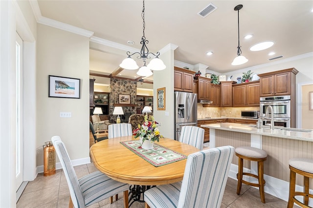 19138 NW 76th Ave, Alachua, FL 32615 - dining area with crown molding, light tile patterned floors, visible vents, and baseboards