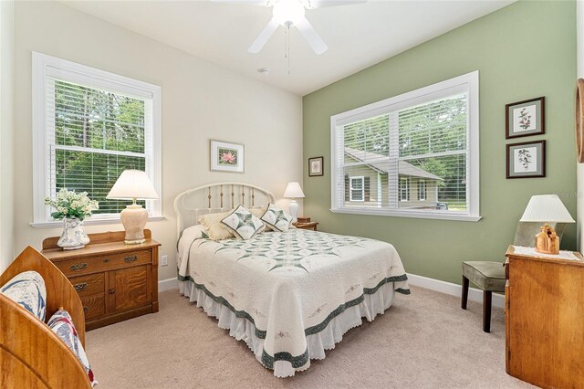 19138 NW 76th Ave, Alachua, FL 32615 - carpeted bedroom with baseboards, a ceiling fan, and multiple windows