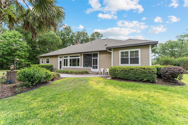 19138 NW 76th Ave, Alachua, FL 32615 - back of house featuring a yard, roof with shingles, and a patio