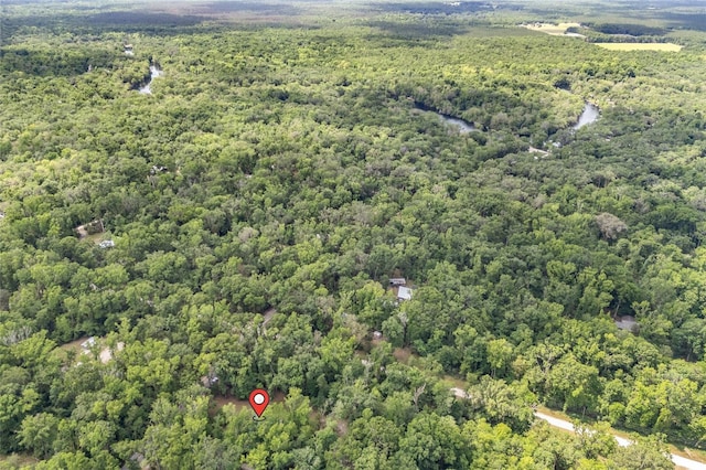 birds eye view of property with a forest view