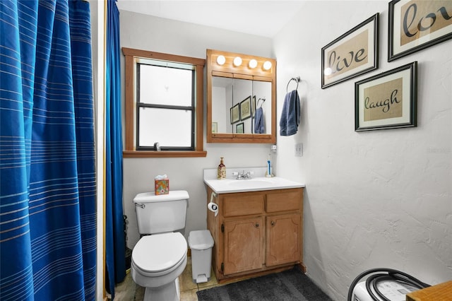 full bathroom with vanity, curtained shower, and toilet