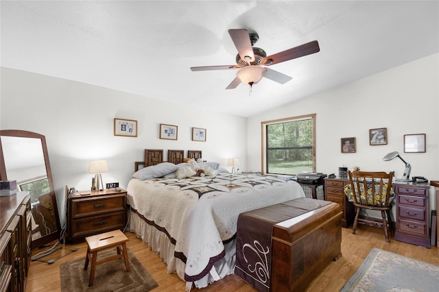bedroom with light wood-style floors, a ceiling fan, and lofted ceiling