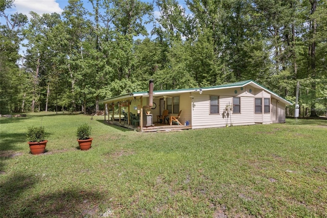 back of house featuring a yard