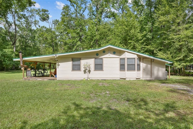 back of property featuring a lawn