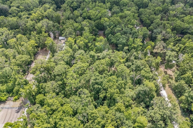 drone / aerial view featuring a wooded view