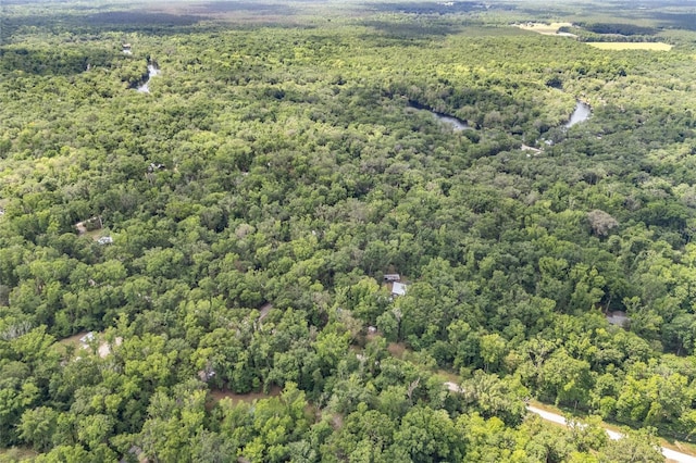 drone / aerial view featuring a forest view