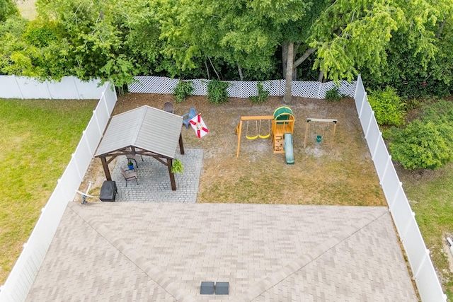 surrounding community featuring a playground, a lawn, and a fenced backyard