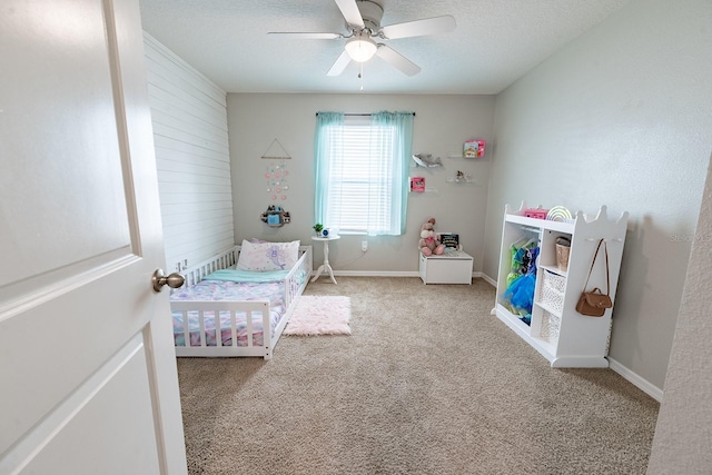 carpeted bedroom with a ceiling fan and baseboards