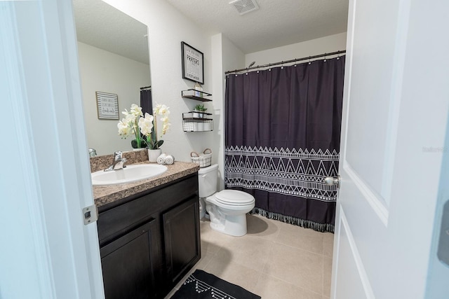 full bath featuring visible vents, vanity, toilet, a textured ceiling, and tile patterned floors