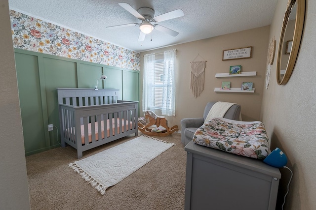 carpeted bedroom with a textured ceiling and ceiling fan