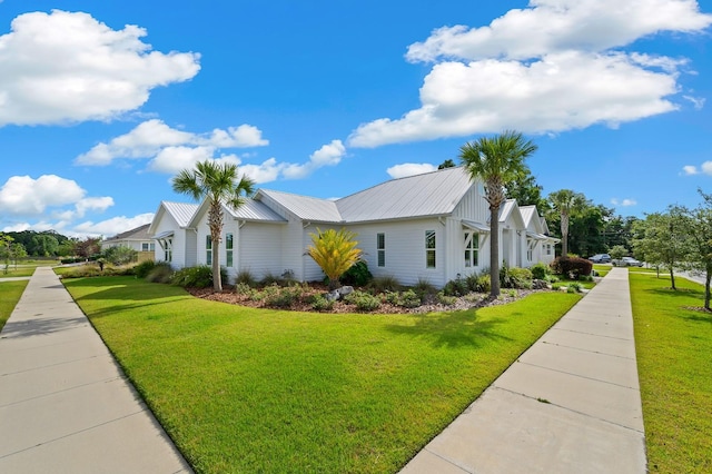 view of property exterior featuring a lawn and metal roof