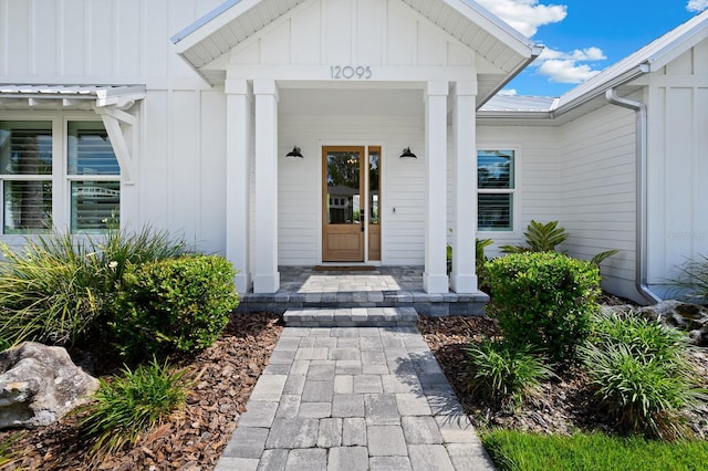 entrance to property featuring board and batten siding and covered porch