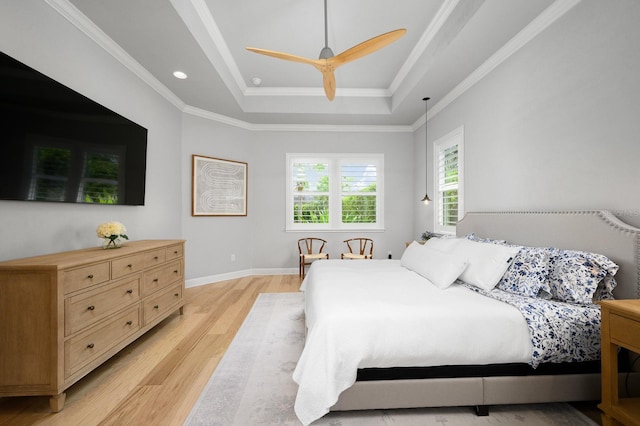 bedroom featuring a raised ceiling, light wood-style flooring, a ceiling fan, crown molding, and recessed lighting