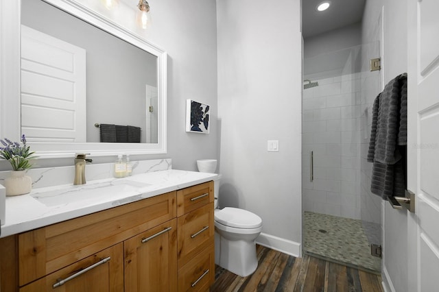 full bath with a stall shower, wood finished floors, baseboards, toilet, and recessed lighting