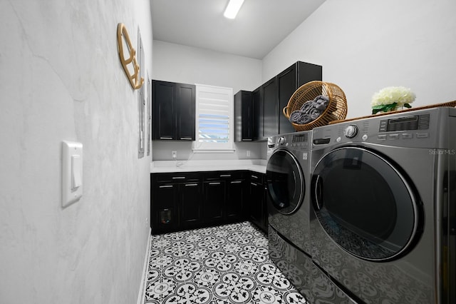 laundry room with cabinet space, independent washer and dryer, and light tile patterned floors
