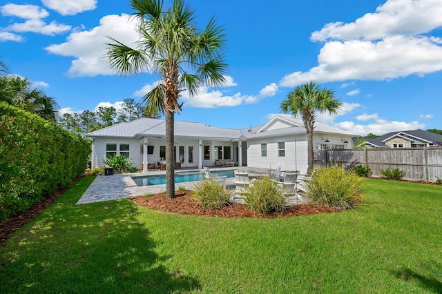 rear view of house featuring a patio and metal roof