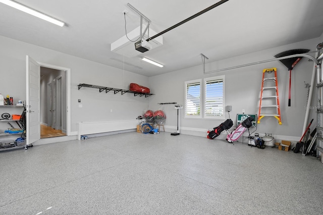 garage with a garage door opener and baseboards