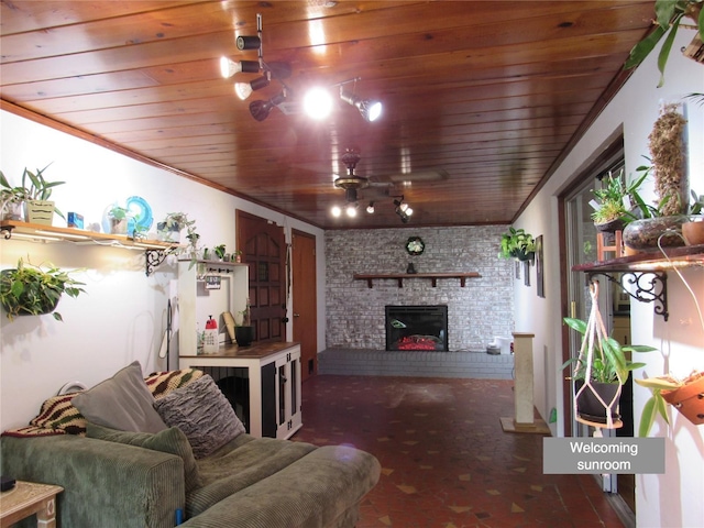living area with a ceiling fan, a brick fireplace, and wooden ceiling