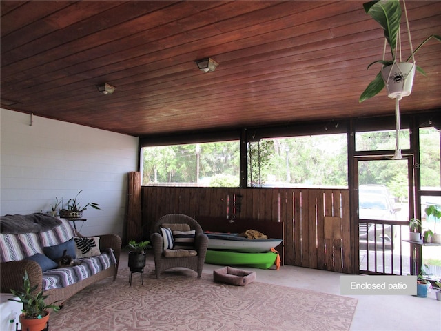 sunroom featuring a healthy amount of sunlight and outdoor lounge area