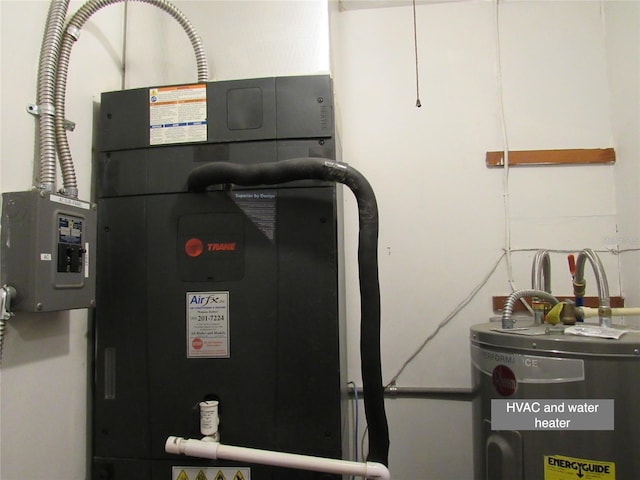 utility room featuring water heater and heating unit