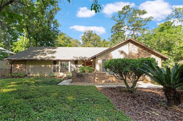 7022 NW 51st Ter, Gainesville, FL 32653 - ranch-style home featuring brick siding and a front yard
