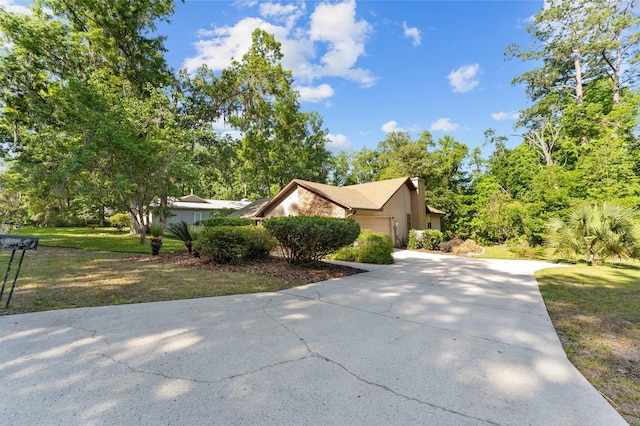 7022 NW 51st Ter, Gainesville, FL 32653 - view of home's exterior with concrete driveway, a garage, and a lawn