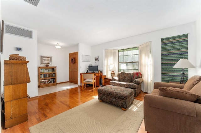7022 NW 51st Ter, Gainesville, FL 32653 - living area featuring visible vents and wood finished floors