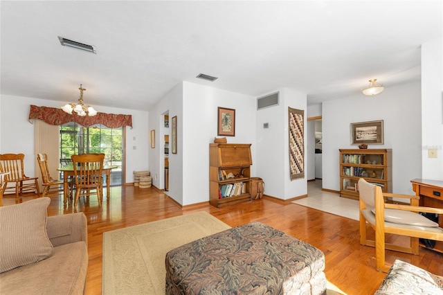 7022 NW 51st Ter, Gainesville, FL 32653 - living area with an inviting chandelier, light wood-style floors, and visible vents