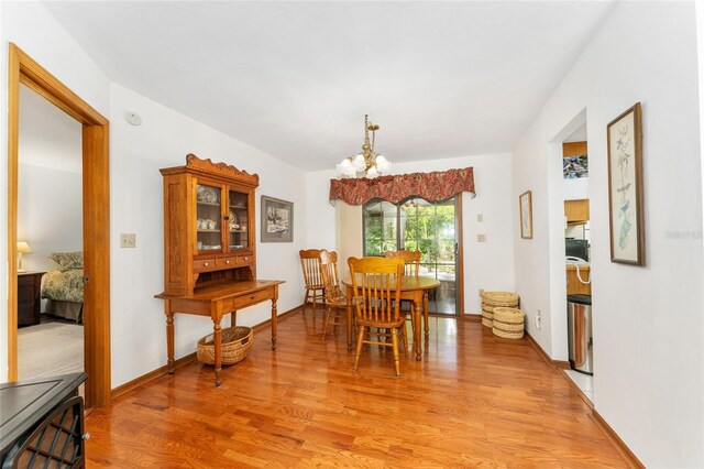 7022 NW 51st Ter, Gainesville, FL 32653 - dining room with a notable chandelier and light wood-style flooring