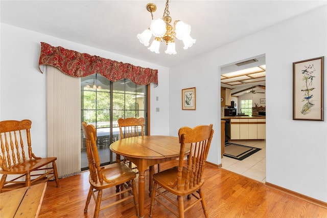 7022 NW 51st Ter, Gainesville, FL 32653 - dining room with light wood finished floors, ceiling fan with notable chandelier, baseboards, and visible vents