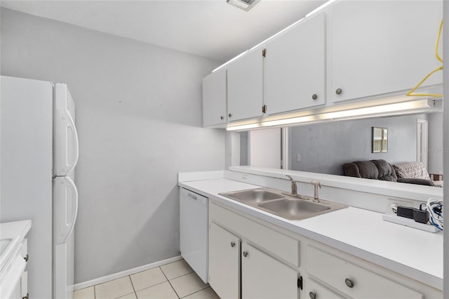 4000 SW 23rd St Unit 2-305, Gainesville, FL 32608 - kitchen featuring white appliances, light countertops, white cabinets, and light tile patterned floors