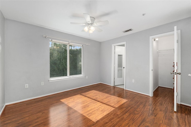 4000 SW 23rd St Unit 2-305, Gainesville, FL 32608 - unfurnished bedroom featuring a walk in closet, wood finished floors, a closet, a ceiling fan, and ensuite bathroom