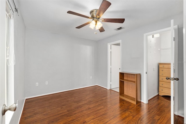 4000 SW 23rd St Unit 2-305, Gainesville, FL 32608 - unfurnished bedroom with a spacious closet, dark wood-type flooring, a closet, and a ceiling fan