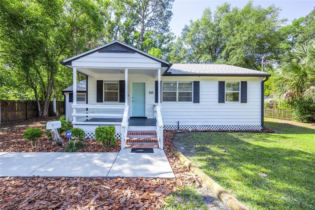 925 NE 7th Pl, Gainesville, FL 32601 - view of front of property with a porch and a shingled roof