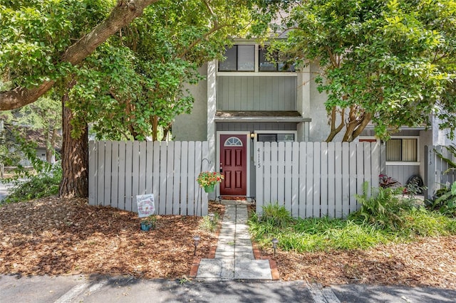 view of front of house with a fenced front yard and stucco siding