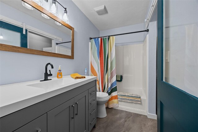 full bathroom with toilet and vanity