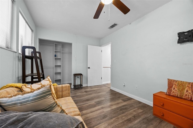 sitting room with ceiling fan, wood finished floors, and baseboards