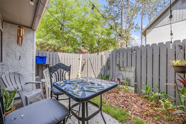 view of patio with a fenced backyard and outdoor dining space