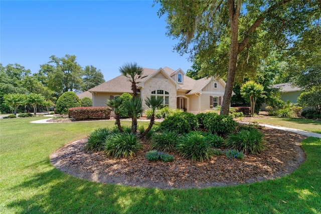 view of front of home with a front yard and stone siding