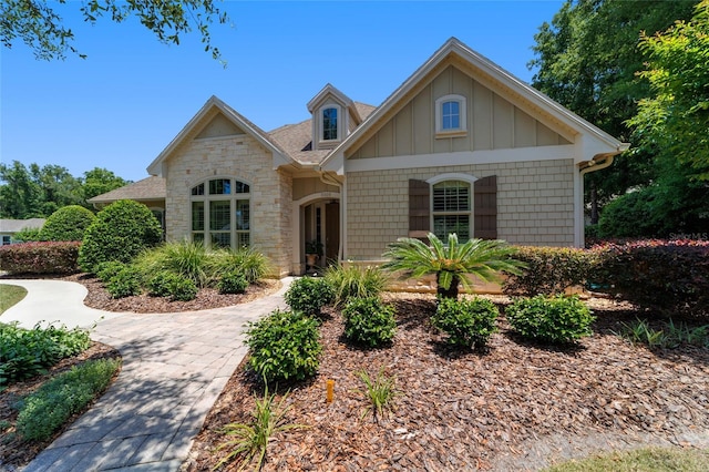 view of front facade featuring stone siding and board and batten siding