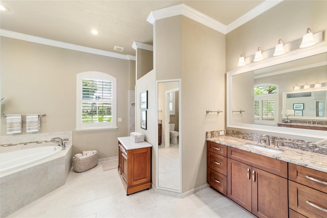 bathroom featuring ornamental molding, a bath, vanity, toilet, and baseboards