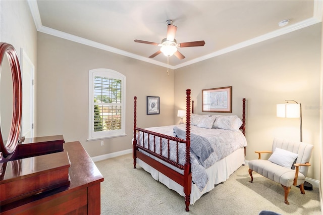 bedroom with light colored carpet, crown molding, baseboards, and ceiling fan
