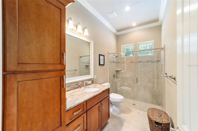 bathroom with a stall shower, toilet, vanity, crown molding, and tile patterned floors