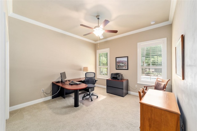 carpeted home office with a ceiling fan, ornamental molding, and baseboards